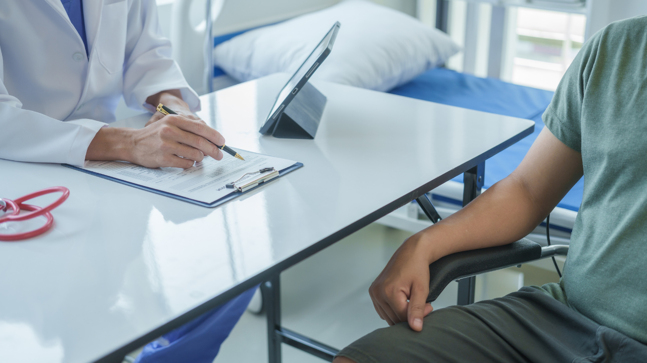 Male doctor is consulting with a young man about prostate cancer and venereal disease and sexual dysfunction about the causes of erectile dysfunction in an examination room. Image Credit: Adobe Stock Images/Ratirath