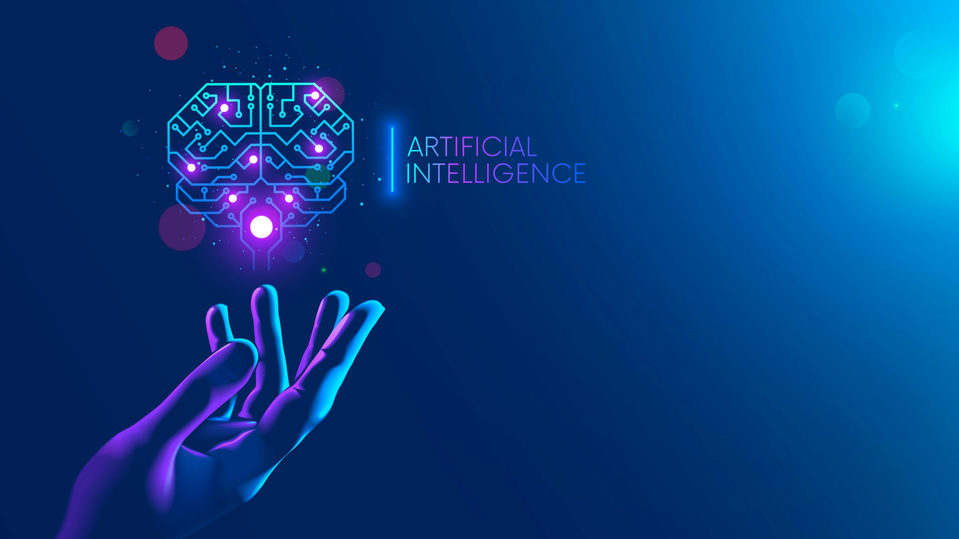 Image credit: AndSus | stock.adobe.com. Circuit board in shape electronic brain with gyrus, symbol ai hanging over hand. Symbol of computer neural networks or artificial intelligence in neon cyberspace with glowing title on palm scientist